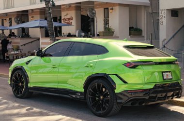 Miami, Florida, ABD - 4 Nisan 2025: lüks spor araba Lamborghini Urus. Lamborghini Urus dışarıda park etmiş. Yeşil spor araba, köşe manzaralı. 2021 Lamborghini Urus spor arazi aracı.