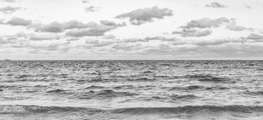 Deniz ufkuyla gökyüzü. Deniz doğarken sakin ufuk manzarası. Deniz manzarasında romantik yaz tatili gündoğumu. Deniz ufku manzarası. Yaz tatilinde bulutlu gökyüzü ve deniz manzarası. Deniz dalgaları.