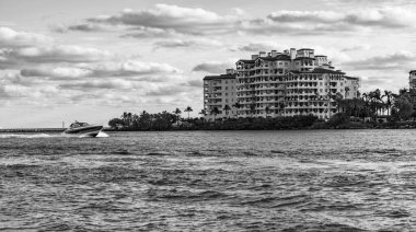 Marinaya yüzen bir tekne. Fisher Adası 'nda lüks bir yat teknesi. Yaz tatili. Fisher Adası konut binası ve lüks yat teknesi. Miami 'de Fisher Adası' na yat gezisi..