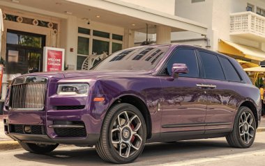 Miami, Florida, ABD - 19 Nisan 2025 Rolls Royce Cullinan SUV arabası. Lüks SUV Rolls Royce Cullinan. Araba Rolls Royce Cullinan dışarı park etmiş. Mor araba, köşe manzaralı..