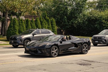 Park Ridge, Illinois, ABD - 29 Ağustos 2024: 2023 Chevrolet Corvette üstü açık araba. Chevrolet Corvette 'in üstü açık lüks arabası. Chevrolet Corvette arabası dışarıda. Chevrolet Corvette, yan görüş..