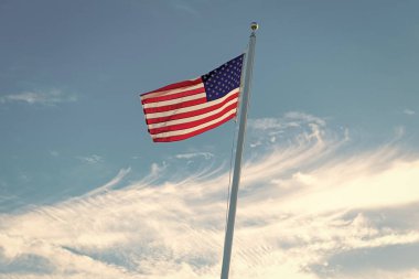 ABD bayrağı. Mavi gökyüzünde Birleşik Devletler bayrağı sallıyor. Bağımsızlık Günü. Vatanseverlik sembolü. Anma Günü için Amerikan Bayrağı ya da 4 Temmuz. Amerikan bayrağı. Bağımsızlık Günü.