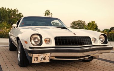 Park Ridge, Illinois, ABD - 21 Ağustos 2024: Otomobil fuarına park edilmiş beyaz araba, köşe manzaralı. Chevrolet Camaro 1976 eski araba. Chevrolet Camaro 'nun beyaz arabası. Chevy Camaro.