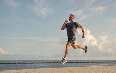 Spor koşuculuğu eğitimi. Sağlıklı yaşam tarzı ve günlük koşular. Koşan koşucu. Spor ve spor. Kumsalda koşan adam. Spor yaşam tarzı. Yazın koşan sporcu. Başarılı ve motive olmuş..