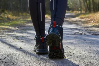 Curonian Spit, Russia - December 19, 2020. Womens legs in Reebok trekking boots