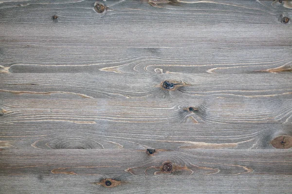 Aged wooden surface with knots and cracks
