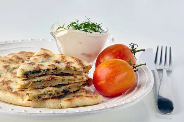 Fried tortillas with cheese and herbs and yoghurt sauce