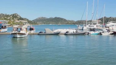 Turkey, Kekova - September 21, 2025.A tranquil moment captured in the busy Kekova harbor, showcasing the variety of maritime life from small dinghies to larger tour boats.