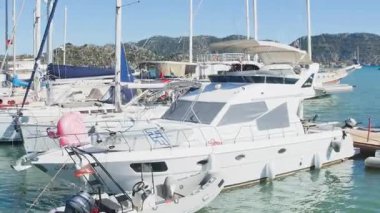 Turkey, Kekova - September 21, 2025.High-quality stock footage of a marina in Kekova, Turkey. The bright scene is filled with the masts of sailing boats and large motor yachts. 