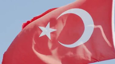 Motion close-up of the Red Flag of Turkey , showcasing the national colors and emblem in detail.