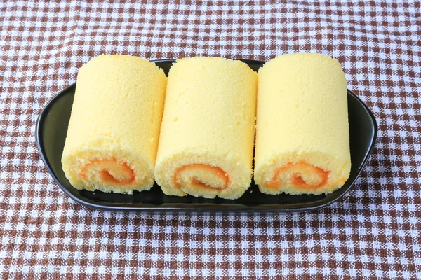 Orange roll cake on plate
