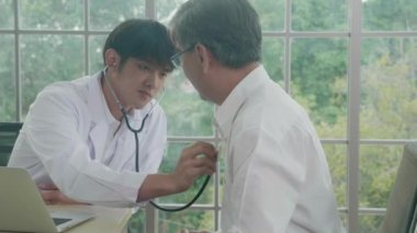 Young doctor examining pulse elderly about cardiology and diagnosis disease at clinic, health of senior and checking health care, consultant and diagnostic about illness for recover, medical concept.