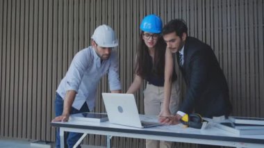 Ekip mühendisi, sistem dizüstü bilgisayarıyla panel güneş hücresini tartışıyor ve inceliyor, mimar grubu, ortakla elektrik ve yenilik, sanayi konsepti hakkında proje planlama kontrolü yapıyor..