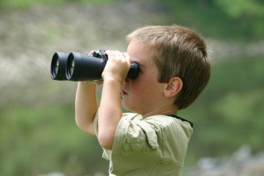 Boy Looking Through Binoculars clipart