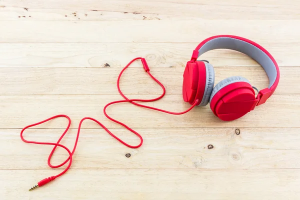 Red Headphones on wood desk — Stock Photo, Image
