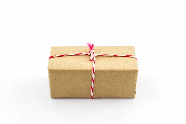 Cardboard carton wrapped with brown paper, tied with string. — Stock Photo, Image