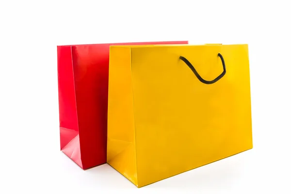 Üres piros és sárga papír bevásárló táska . — Stock Fotó