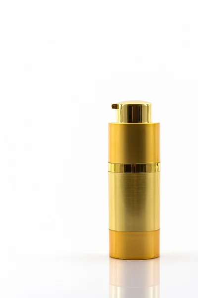 Kosmetikflasche, goldene Leerverpackung. — Stockfoto