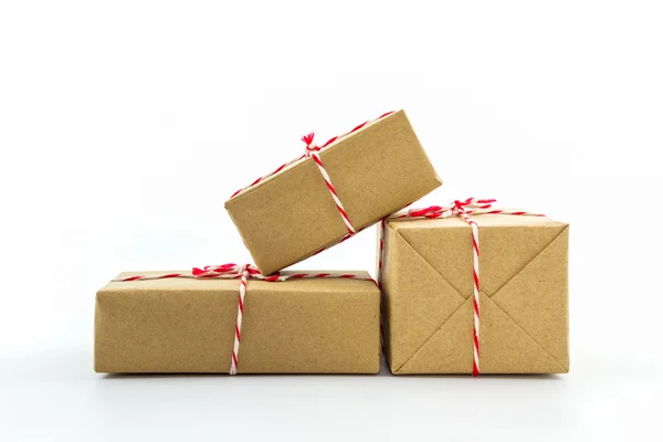 Cardboard carton wrapped with brown paper, tied with string. — Stock Photo, Image