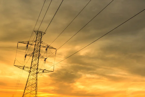 High-voltage tower with sunset sky. — Stock Photo, Image