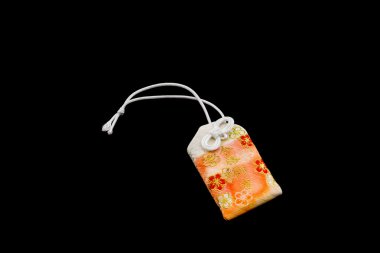 Japanese charms commonly sold at religious sites Shinto and Budd clipart