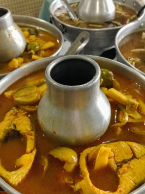 Yellow fish curry in hot pot.