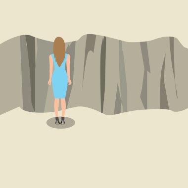 Young woman standing and looking at the edge of a cliff.