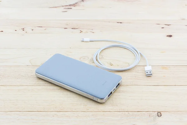 Graue Powerbank und USB-Kabel für Smartphone. — Stockfoto