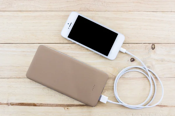 Smartphone dengan powerbank emas . — Stok Foto