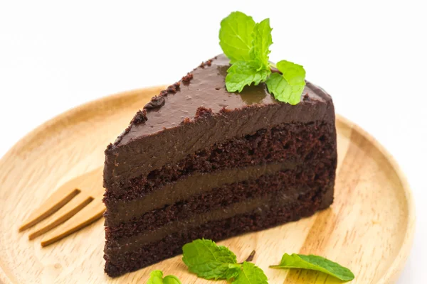 Chocolate cake slice in wooden plate. — Stock Photo, Image