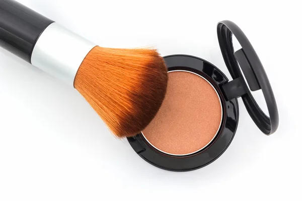 Closeup of face powder and makeup brush. Royalty Free Stock Images