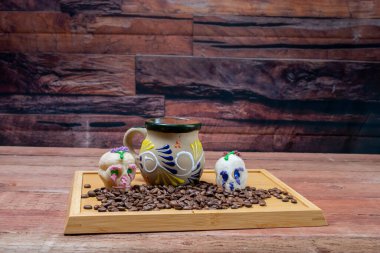 Ölü günü süslemeli Meksika kahvesi ve kahve çekirdekleri. Kafatası şekeri sunarlar.