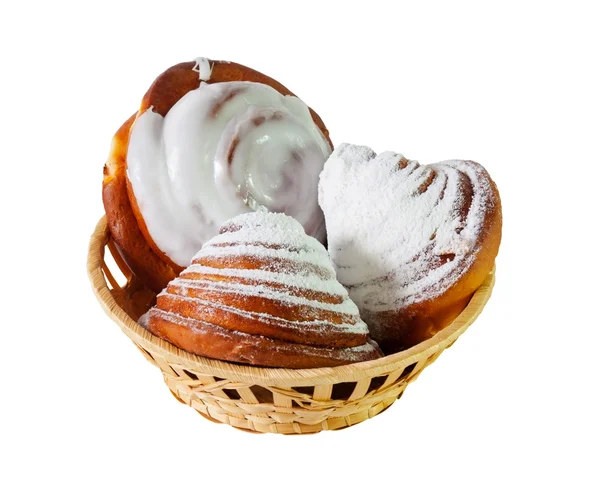 Cinnamon bun with icing and cinnamon buns with sugar powder in basket isolated — Stock Photo, Image