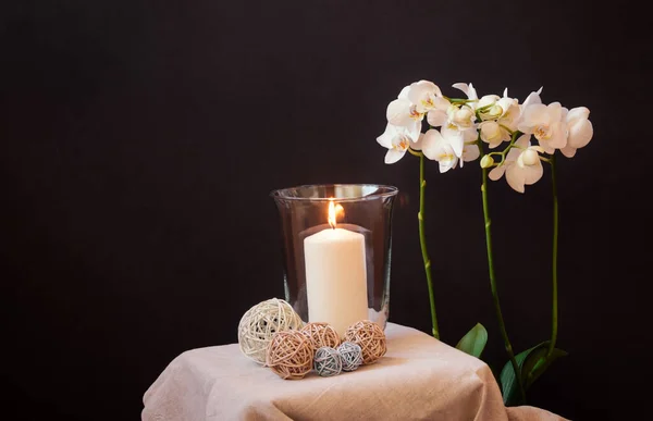 Burning Candle Glass Vase Decorative Balls White Orchid Dark Background — Stock Photo, Image
