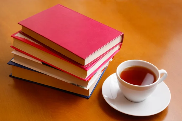 Taza de té y pila de libros — Foto de Stock