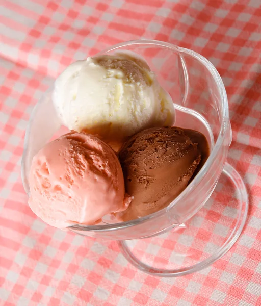 Three scoops of chocolate, strawberry and vanilla ice cream in g — Stock Photo, Image