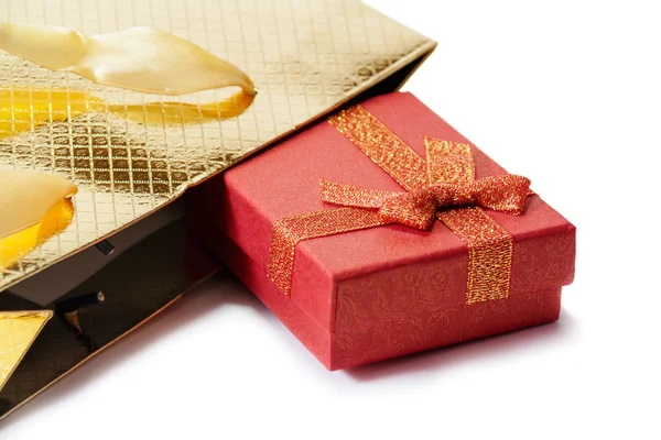 Gold gift bag and red gift box isolated on white. Selective focu — Stockfoto