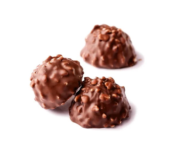 Dulces de chocolate con nueces de cerca en blanco —  Fotos de Stock