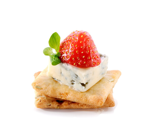 gourmet snack on crackers with  Dor Blue cheese and strawberry close-up isolated on white