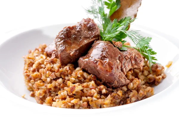 Dish of buckwheat porridge with meat close-up — Stock Photo, Image