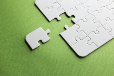 Bir parçası eksik ama uymayan beyaz bir bulmaca. yeşil arkaplan, kopyalama alanı