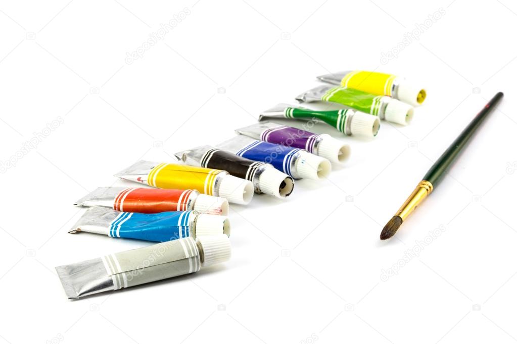 Tubes of  colored paint and brush on white background