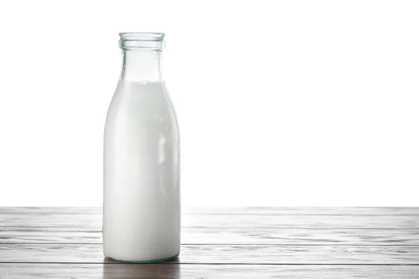 Botella de leche en la mesa — Foto de Stock