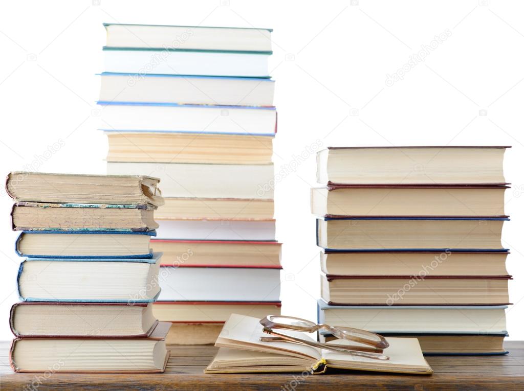 Stacks of books and eyeglasses