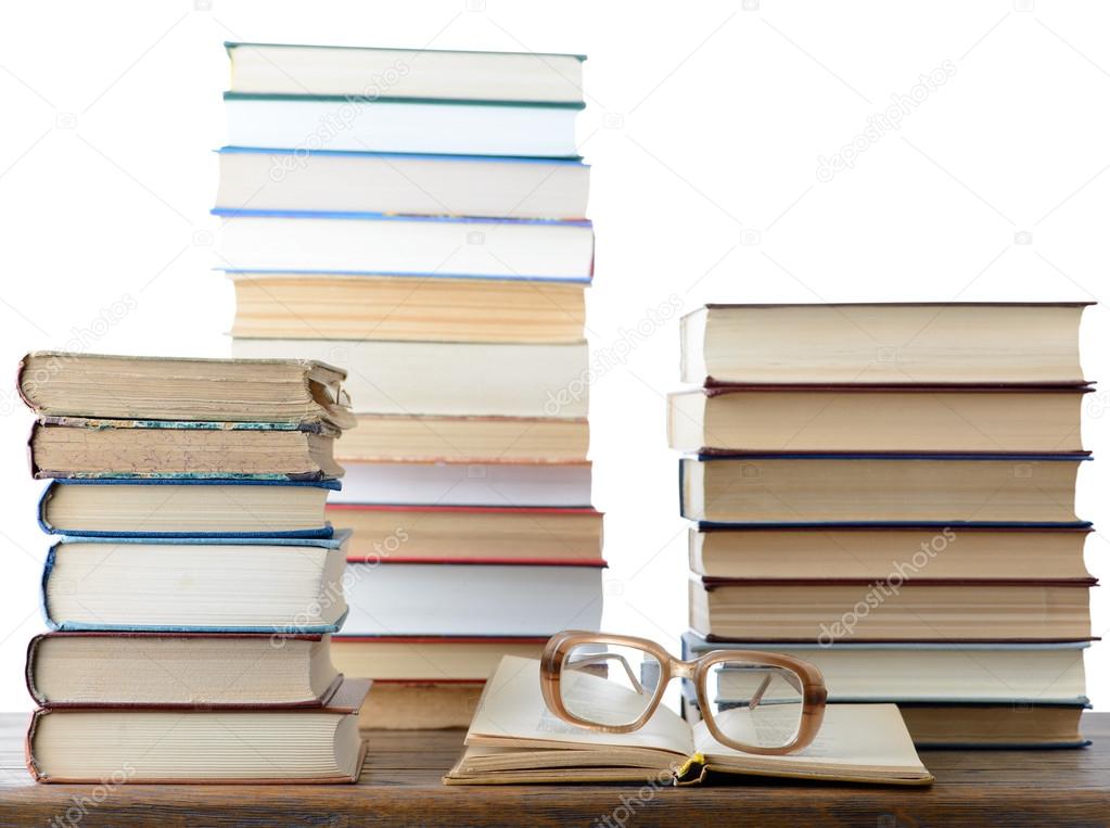Stacks of books with vintage eyeglasses