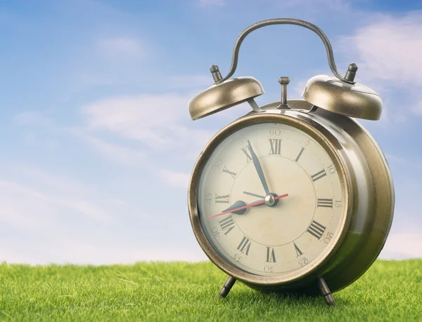 Alarm clock on lawn — Stock Photo, Image