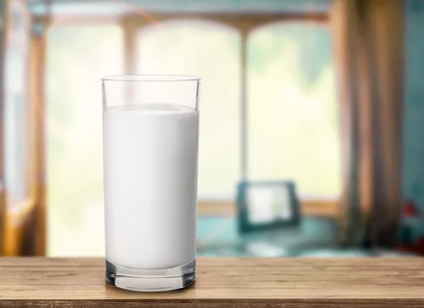 Glass of milk on wooden table — Stock Photo, Image