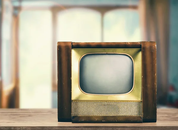 Vintage TV on wooden table — Stock Photo, Image