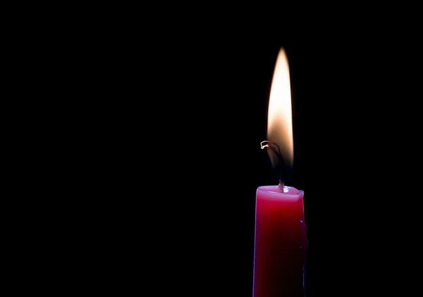 Burning candle over black — Stock Photo, Image