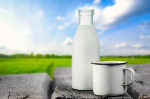 Milk bottle and cup — Stock Photo, Image